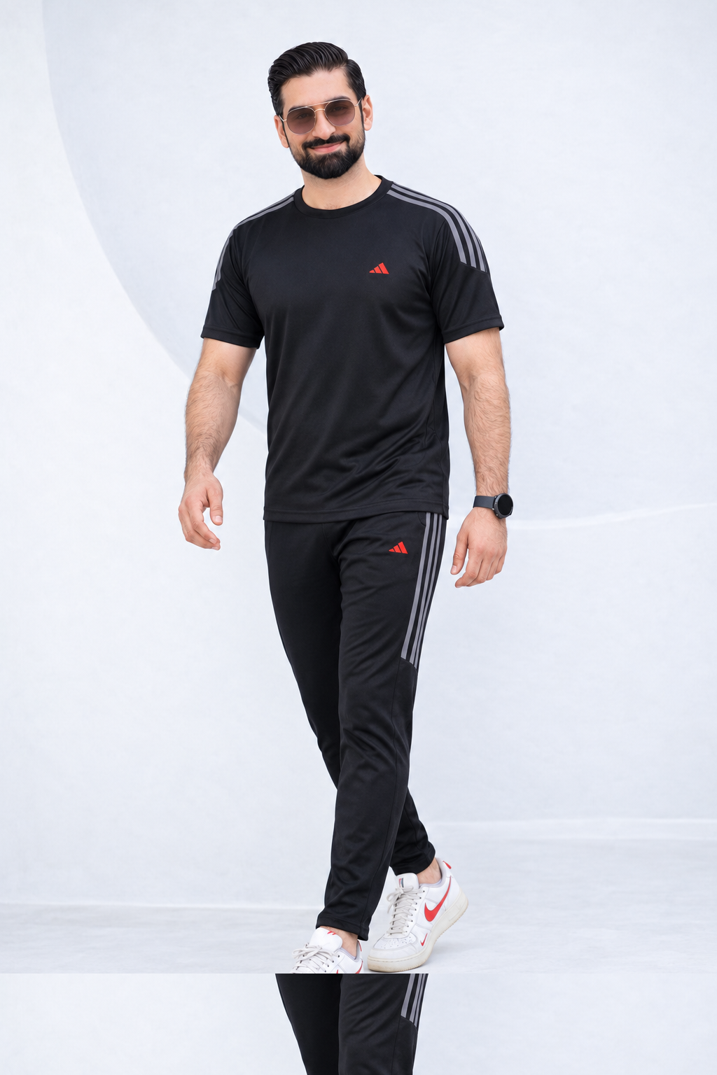 ADI black tracksuit with grey stripes on male model, full outfit view with short sleeves