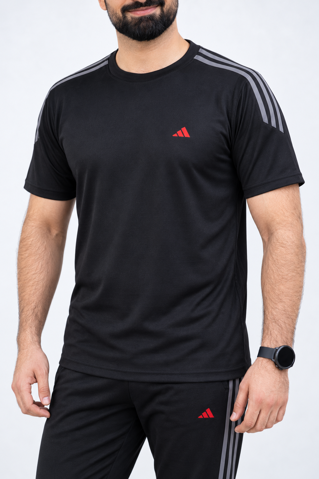 ADI black short-sleeve tracksuit top detail showing three grey shoulder stripes and red chest logo